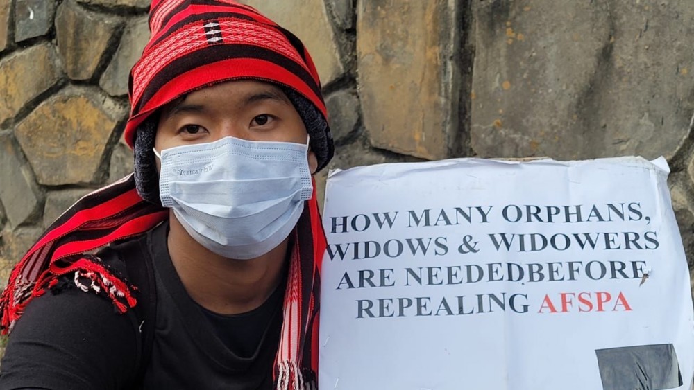 A marcher holds up a banner demanding repeal of the Armed Forces Special Powers Act in Kohima on January 11. (Morung File Photo)